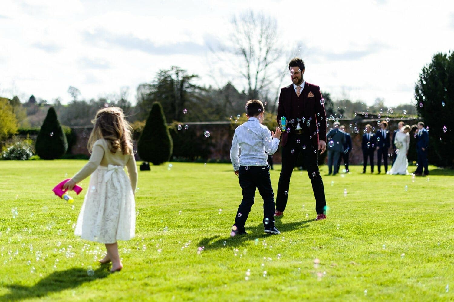 Brympton House wedding - bubbles on the lawn