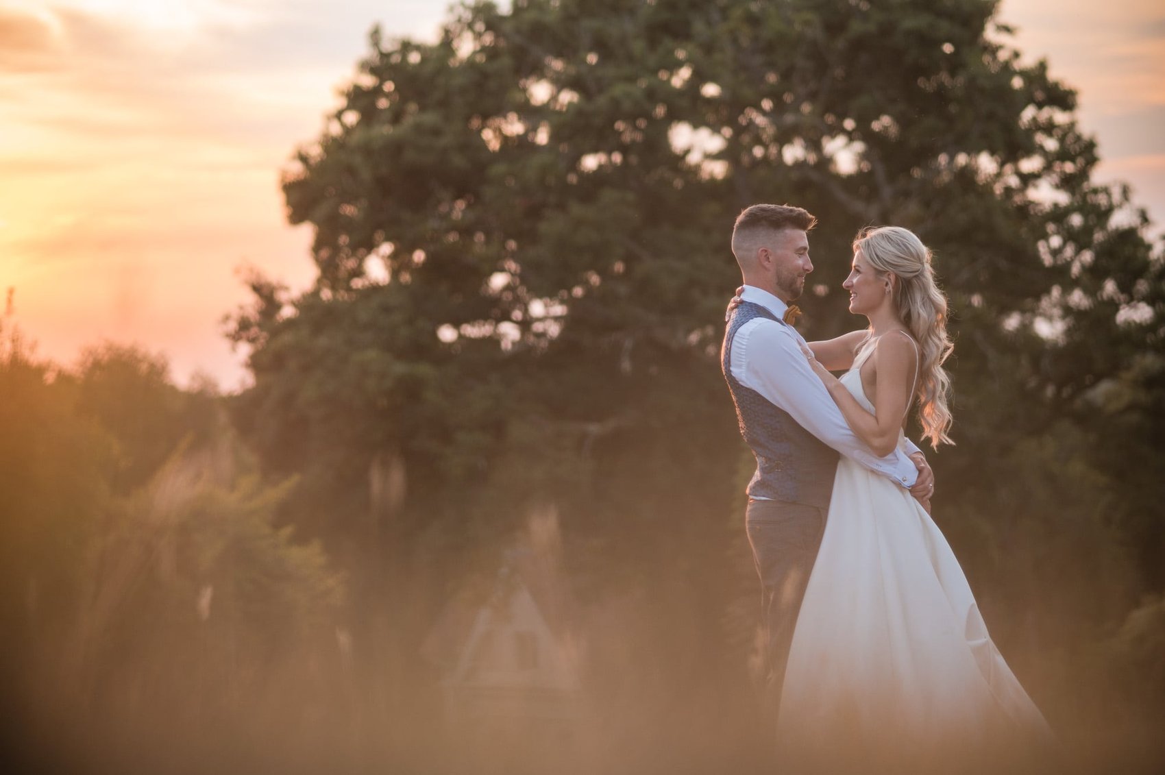 Sunset at Hale park House wedding with bride and groom long grass