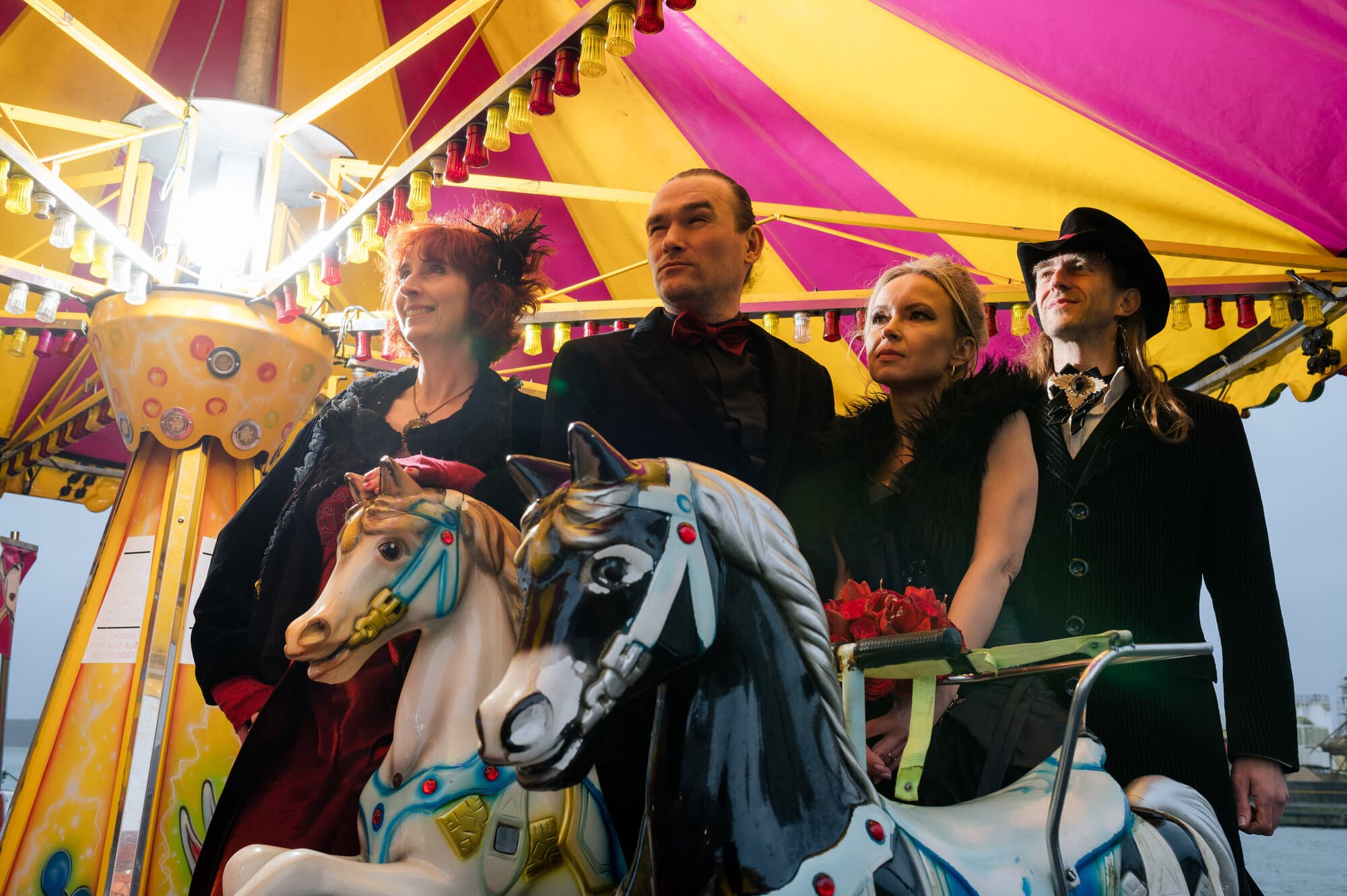 Having fun on the fairground ride at a Goth Wedding in Poole