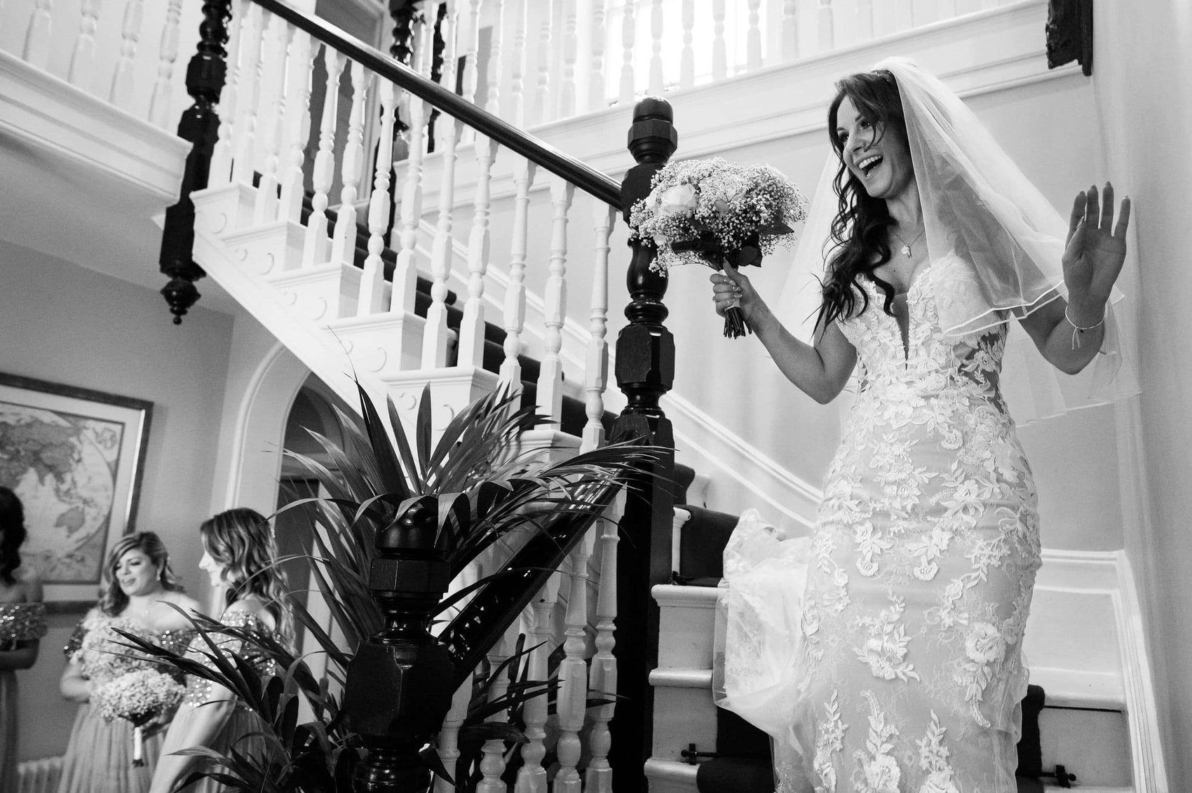 Bride descends the staircase at Abbots Court wedding venue