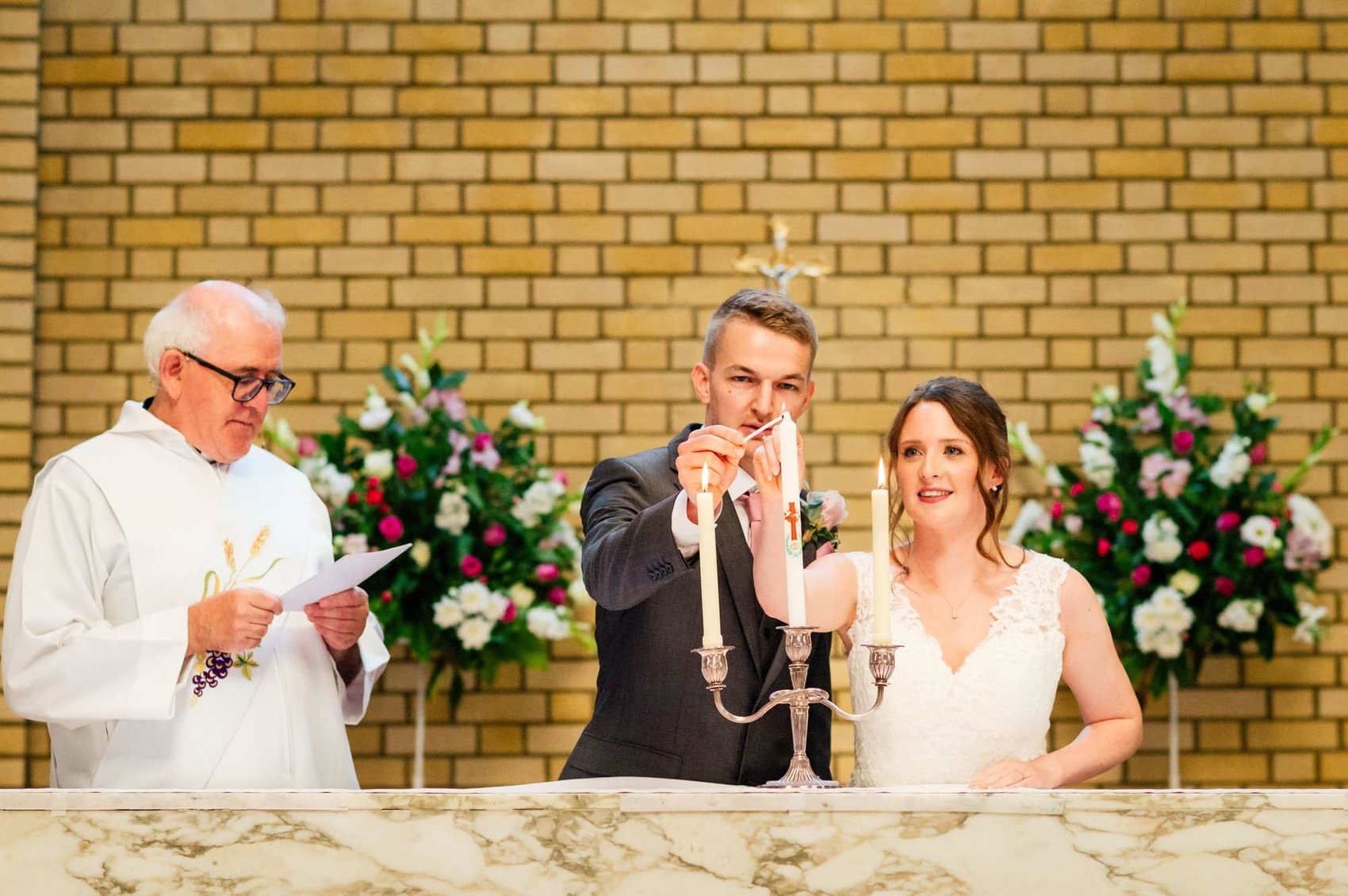 Lighting the centre candle in St Mary's Catholic Church wedding ceremony