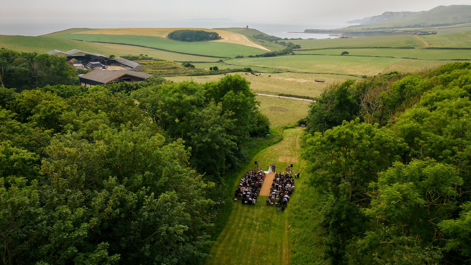 Smedmore House Wedding venue - Outdoor ceremony photographed from the air showing the Jurassic coastline