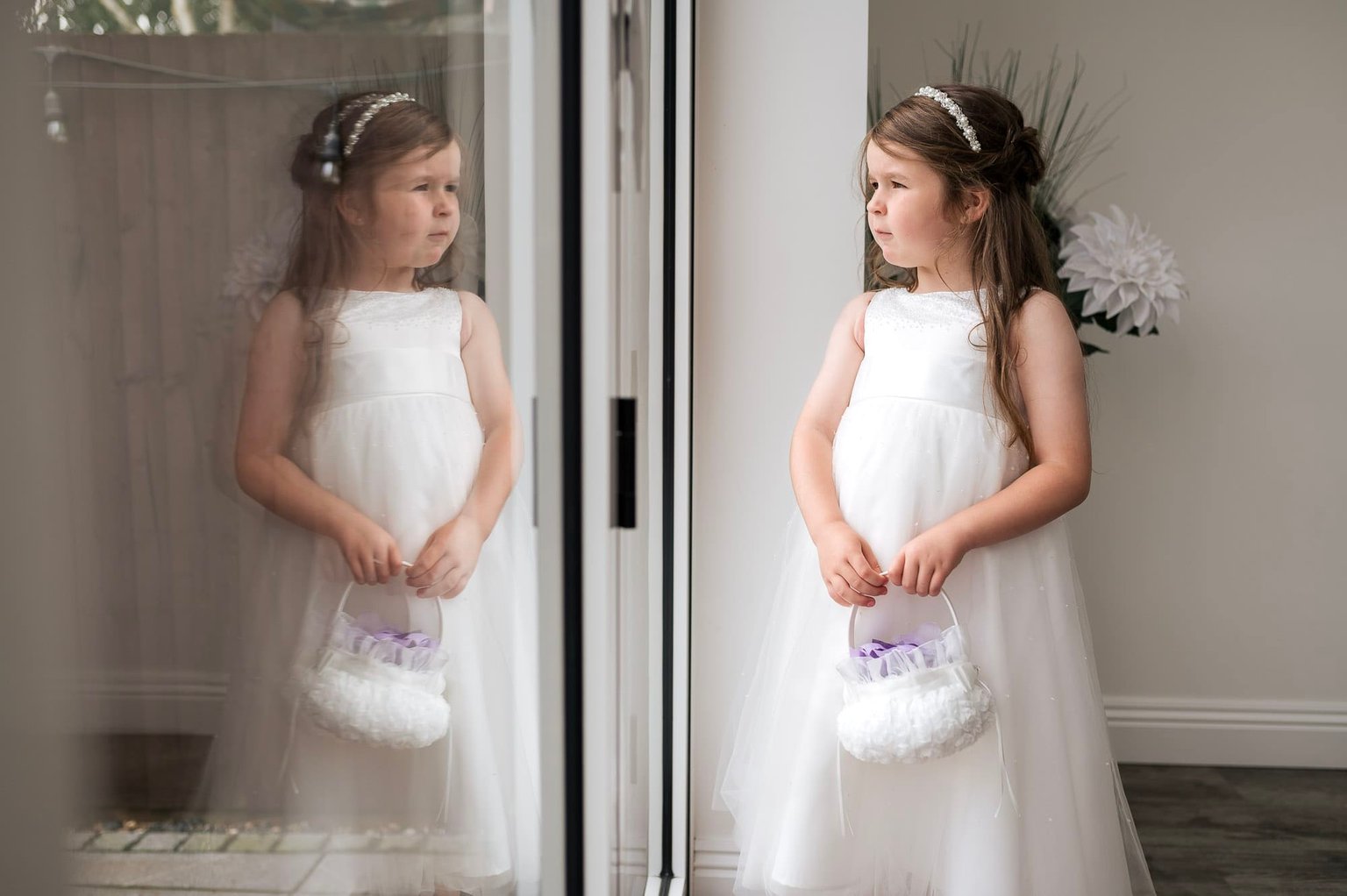 Flowergirl looks out of the window with a relection