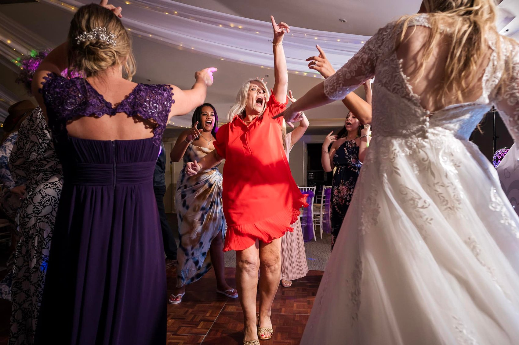 Mother of the Groom dancing in red dress. WPJA award winning photo