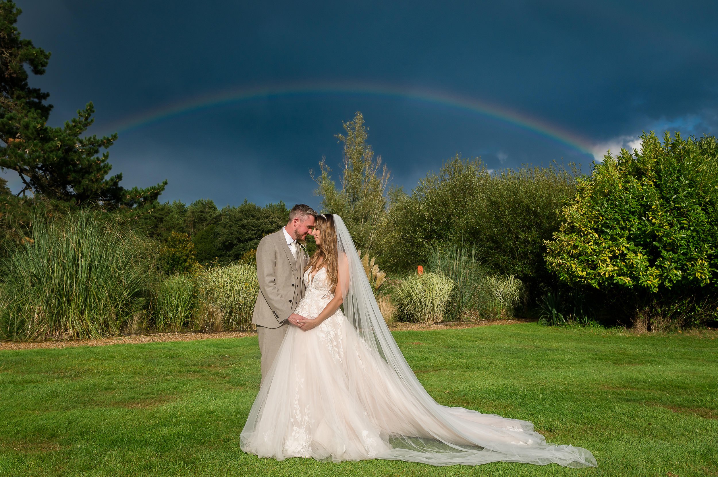 Rainbow over the bride and groom at Hethfelton House wedding