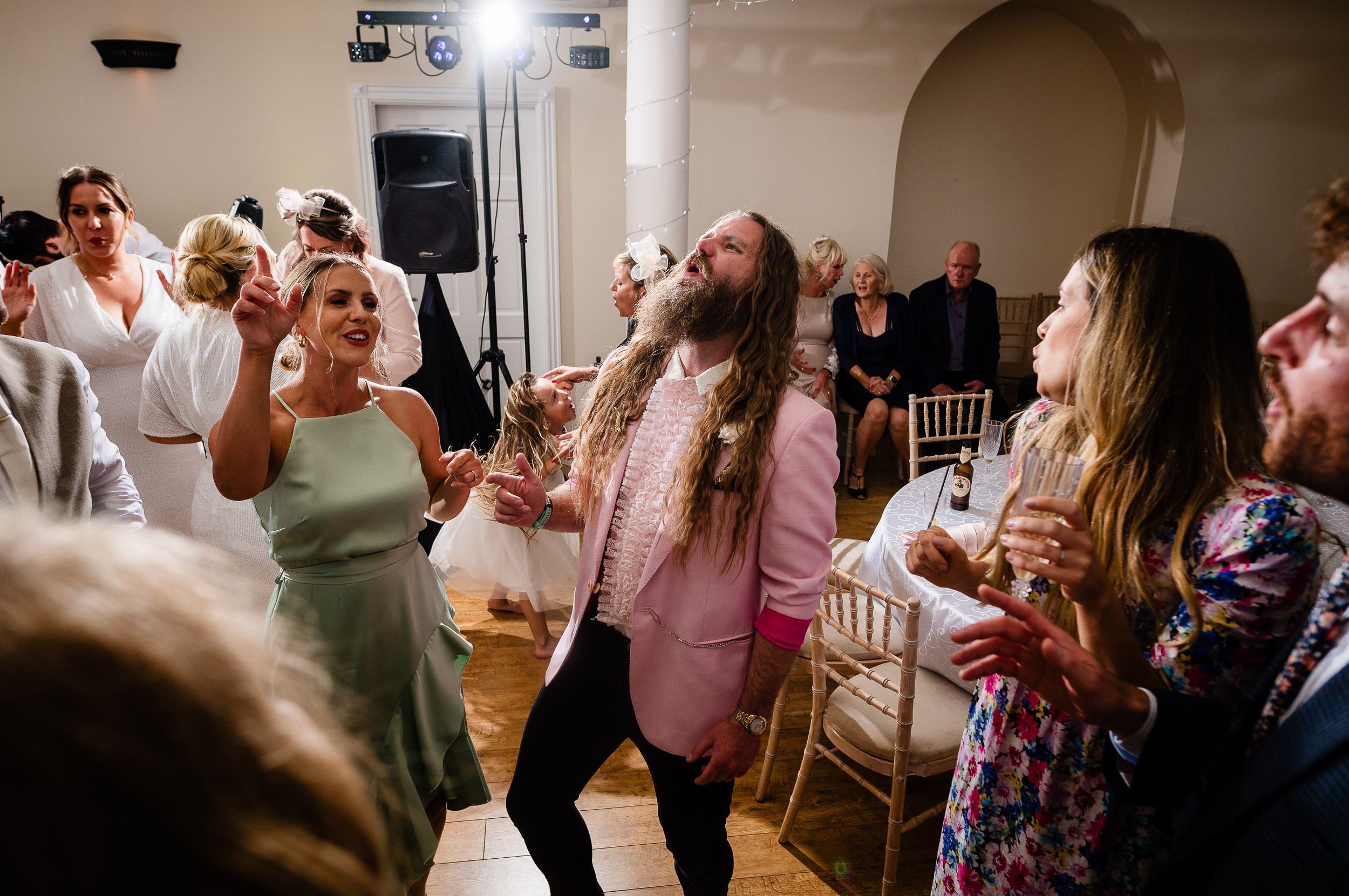 Guy in Pink jacket enjoying the wedding dancefloor