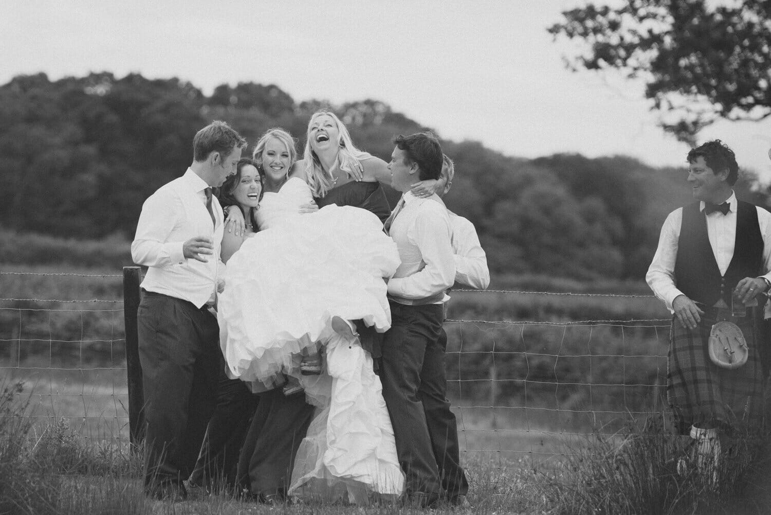 Lifting the bride Milton Abbey Wedding