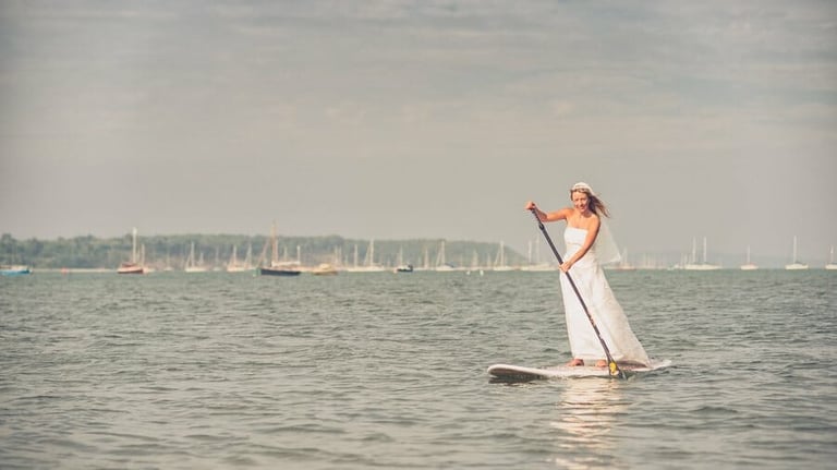 Bride takes a ride on a SUP in her Wedding dress