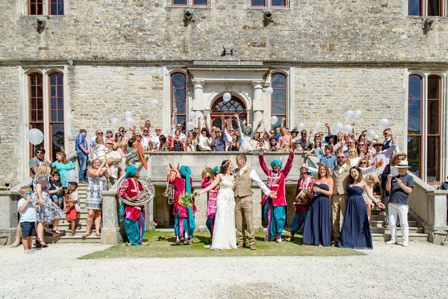 Colourful wedding group photo at Camp Bestival