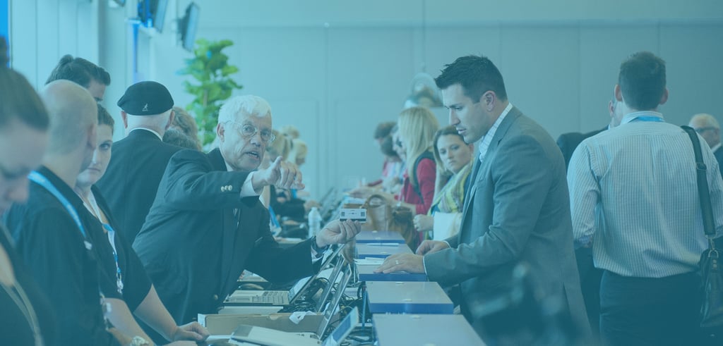 People helping other register at a long desk