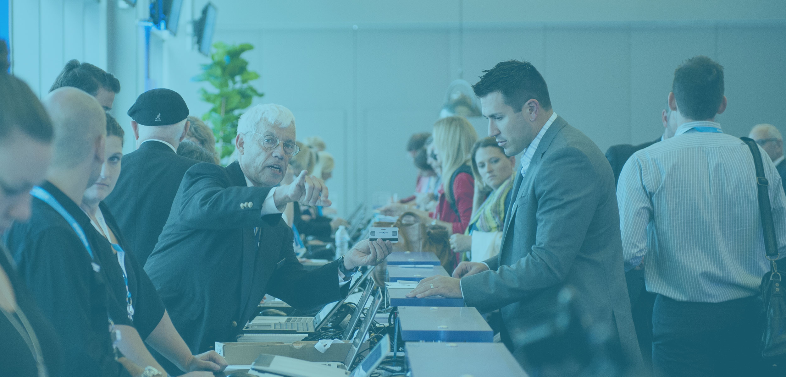People helping other register at a long desk