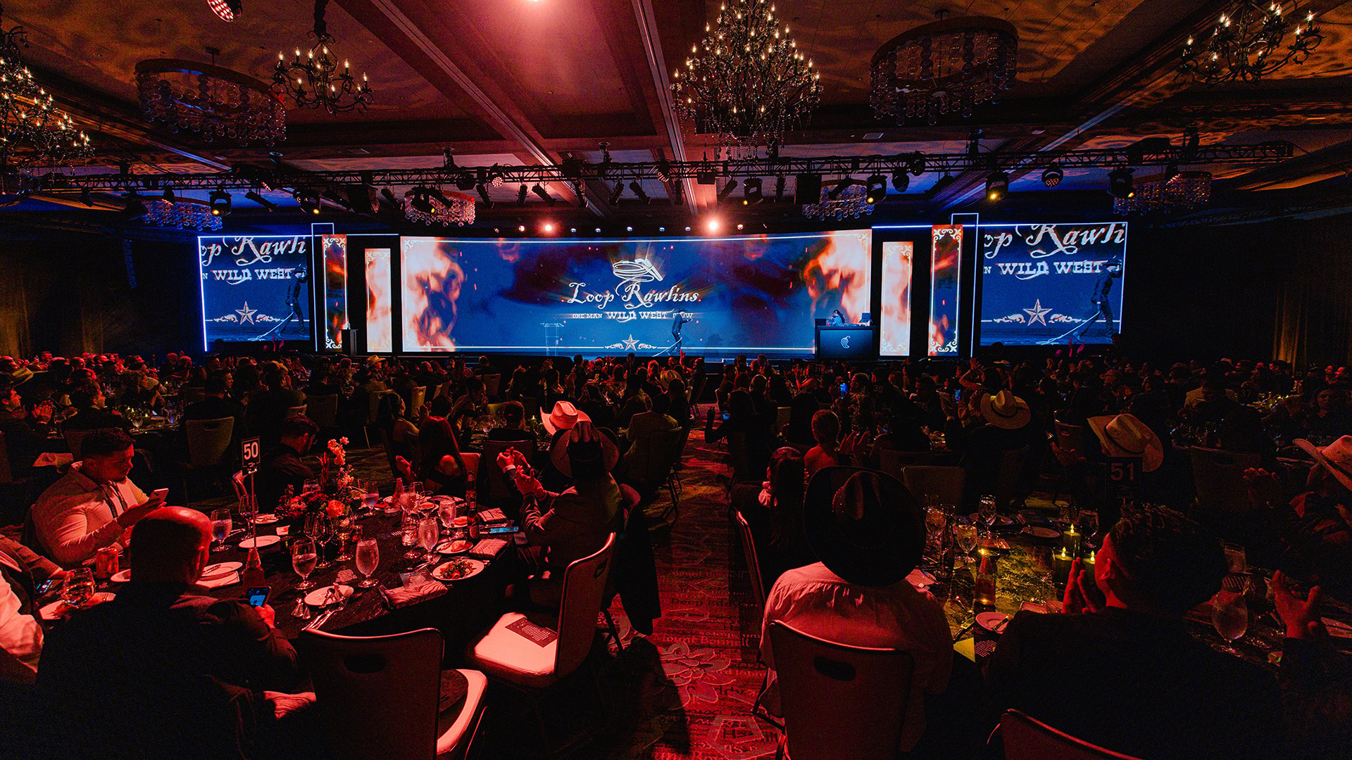 Large corporate conference general session with Chipotle branding, stage production, and seated attendees