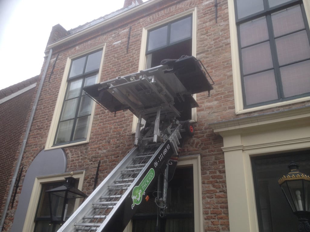 movers carrying boxes into a truck