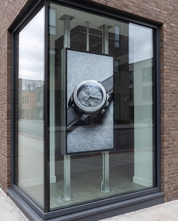 High-brightness LCD display installed in a shop window, switched on and readable in daylight