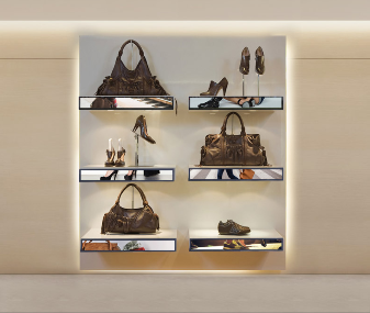 Bar-type displays built into retail shelving beneath handbags and shoes