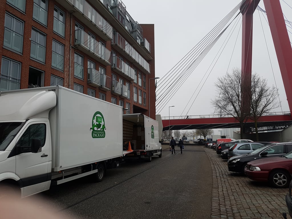friendly movers carrying boxes into a moving truck