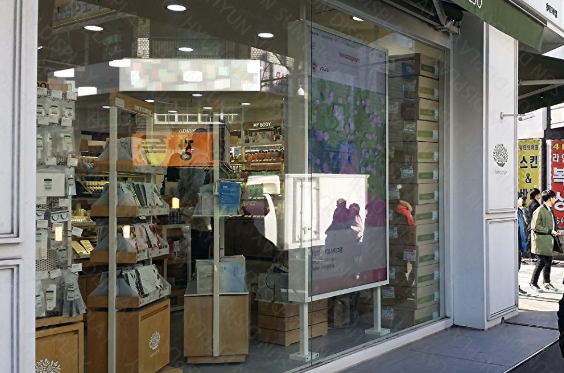 Portrait display in the window of a cosmetics store on a shopping street