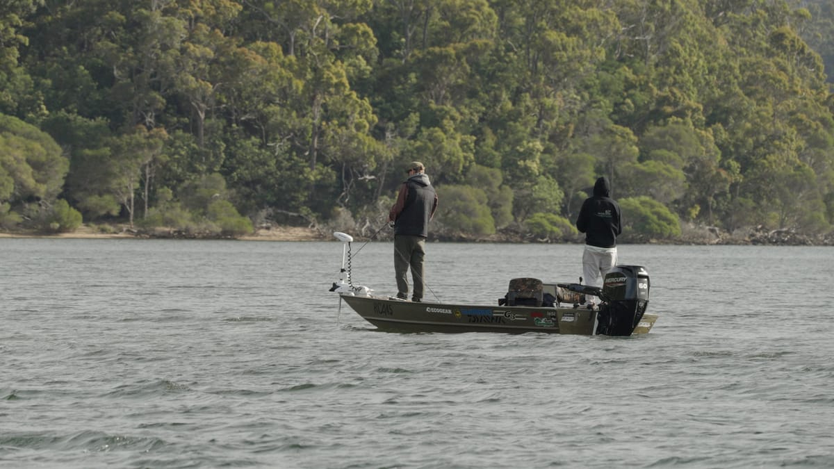 Two anglers drifting the chop in a camo tinny