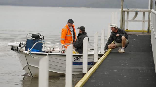 Checking in with the marshal at the Mallacoota jetty in the drizzle