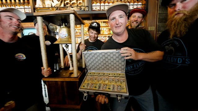 The winning crew at the Scallywags bar with the bell and the case of fifties