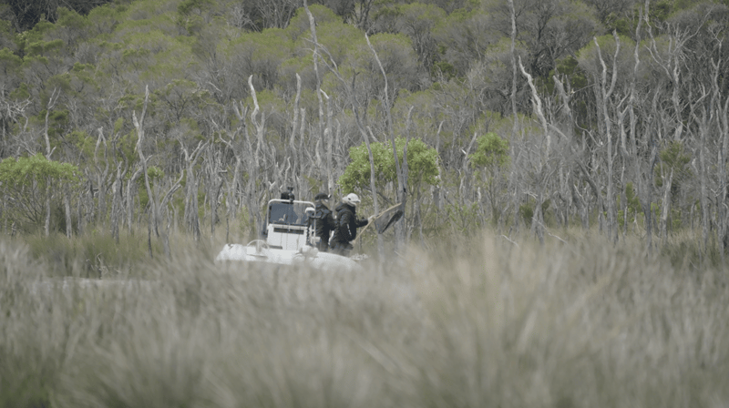 Working a fish through the bush-lined channels at Mallacoota