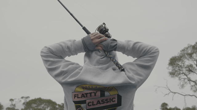 Rod slung over the shoulders of a Flatty Classic hoodie