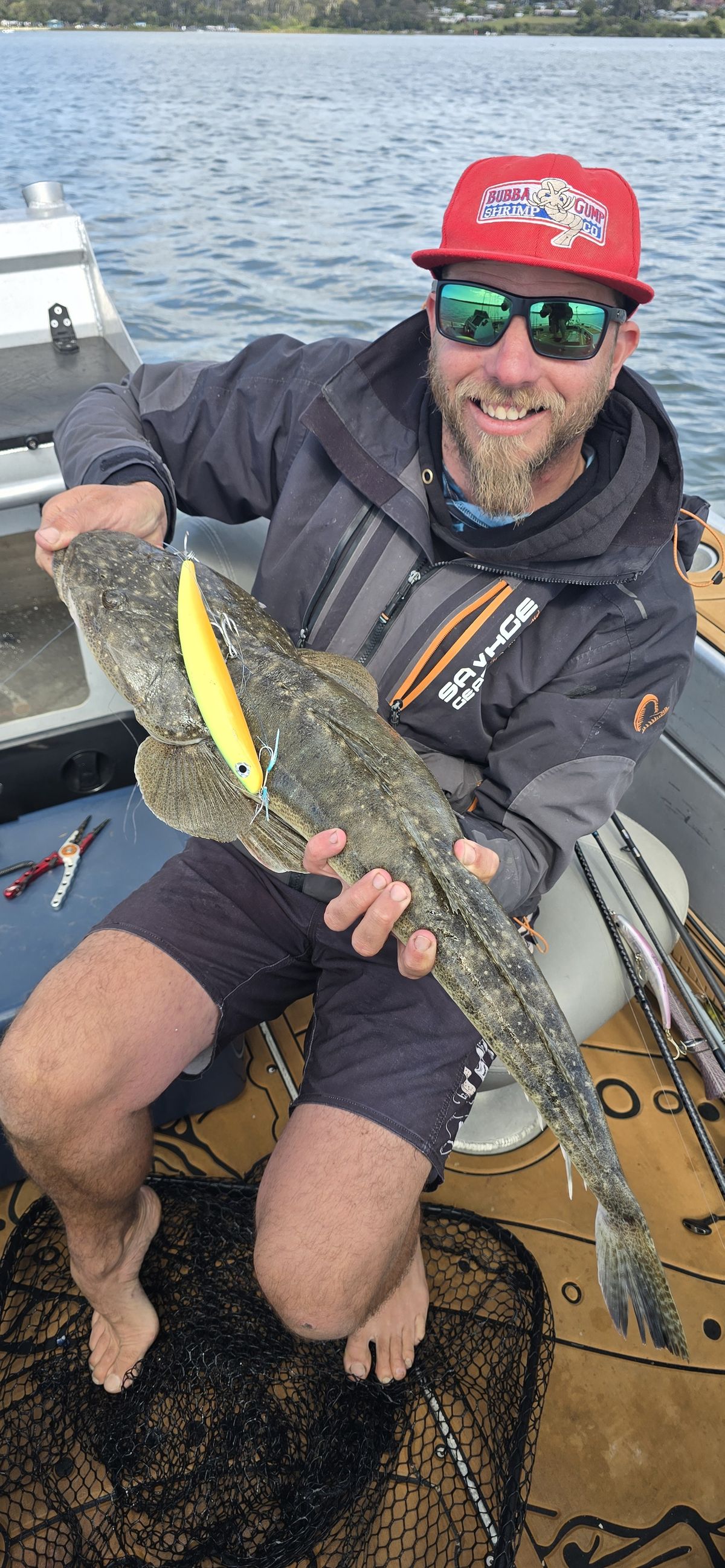 Lucas holding a big flathead with the yellow bent minnow still pinned in its jaw