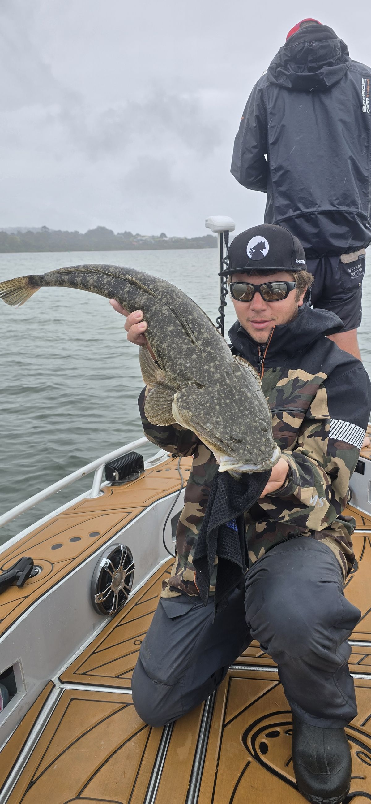 Prykey holding his kicker flathead on the boat