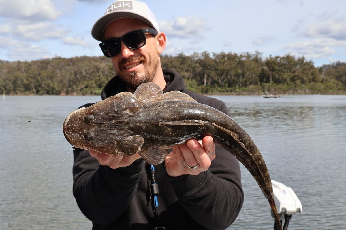 Dan Spence holding a dusky flathead caught on a Nomad Dozer