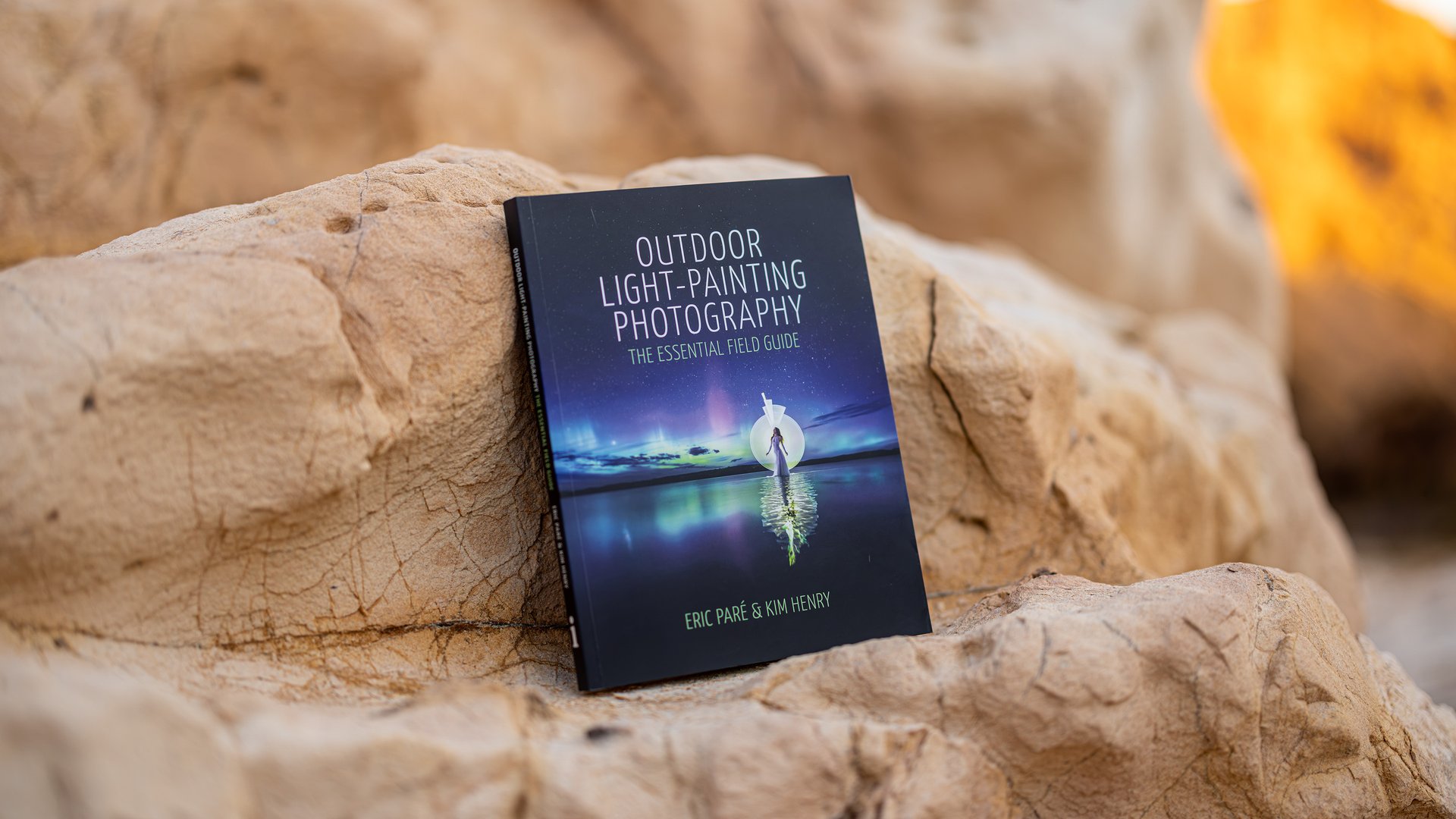 Le livre Outdoor Light-Painting Photography: The Essential Field Guide posé parmi des rochers ensoleillés à Minorque.