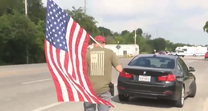 [WATCH] Man Shows Up Near Texas School Shooting Scene With Gun And American Flag