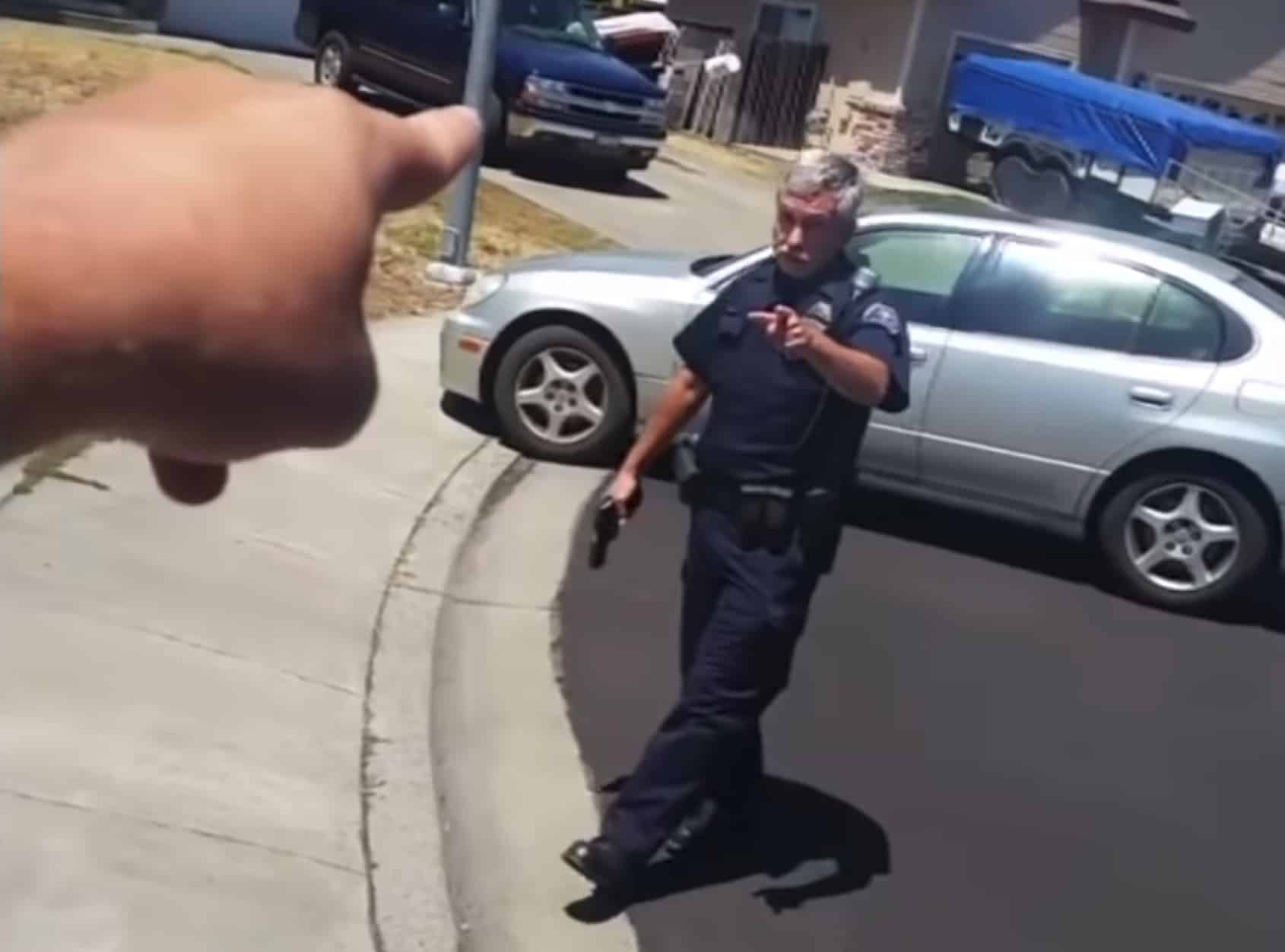 [WATCH] Cop Draws Gun On Man Who Was Filming Him In Neighborhood