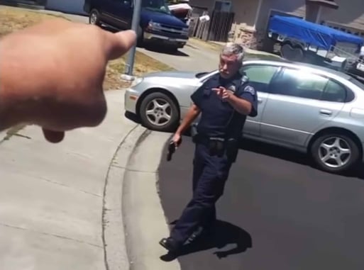 [WATCH] Cop Draws Gun On Man Who Was Filming Him In Neighborhood