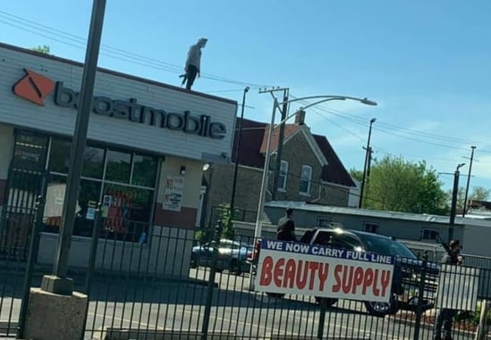Business Owner Guards His Livelihood From The Roof, Armed With A Rifle And Armed Buddies Below
