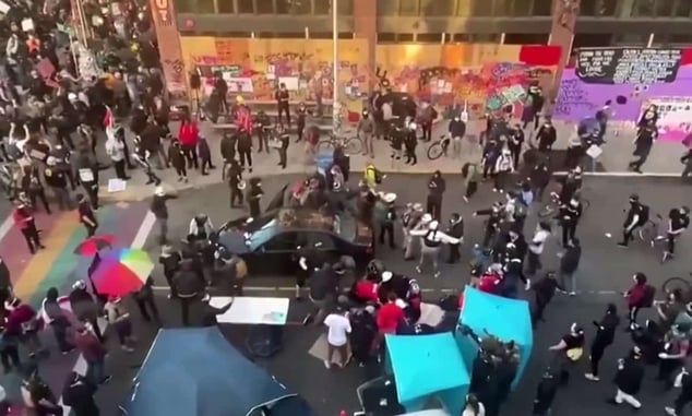 Man Drives Towards Crowd Of Protesters, Shoots One, Gets Out Of Car Brandishing Handgun
