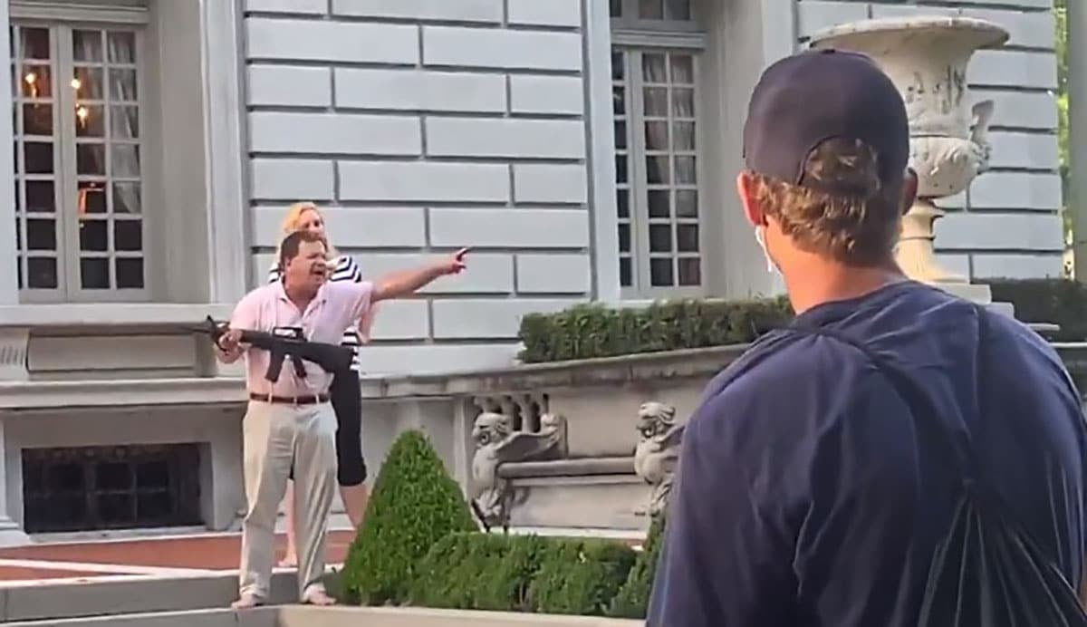 [VIDEO] Couple Points Guns At Protesters As They Walk Past Their Home, Showing Poor Gun Handling Skills Along The Way