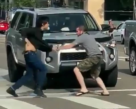 [VIDEO] Man Backed Up Into Car By Aggressor, Aggressor Knocked Out During Ensuing Fight