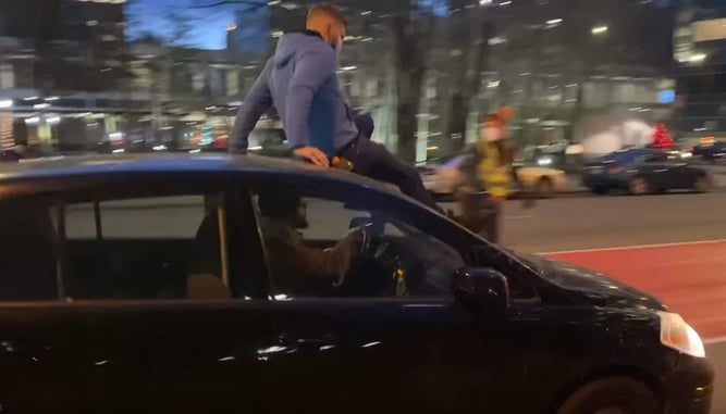 Vehicle Drives Through Crowd Protesting In Minneapolis, Guy On Roof Decides He Wants Down