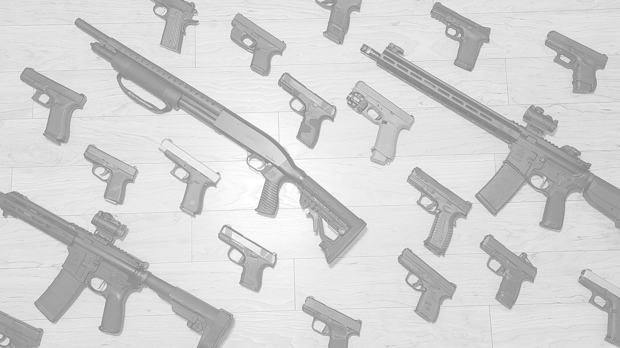 a group of guns on a white surface