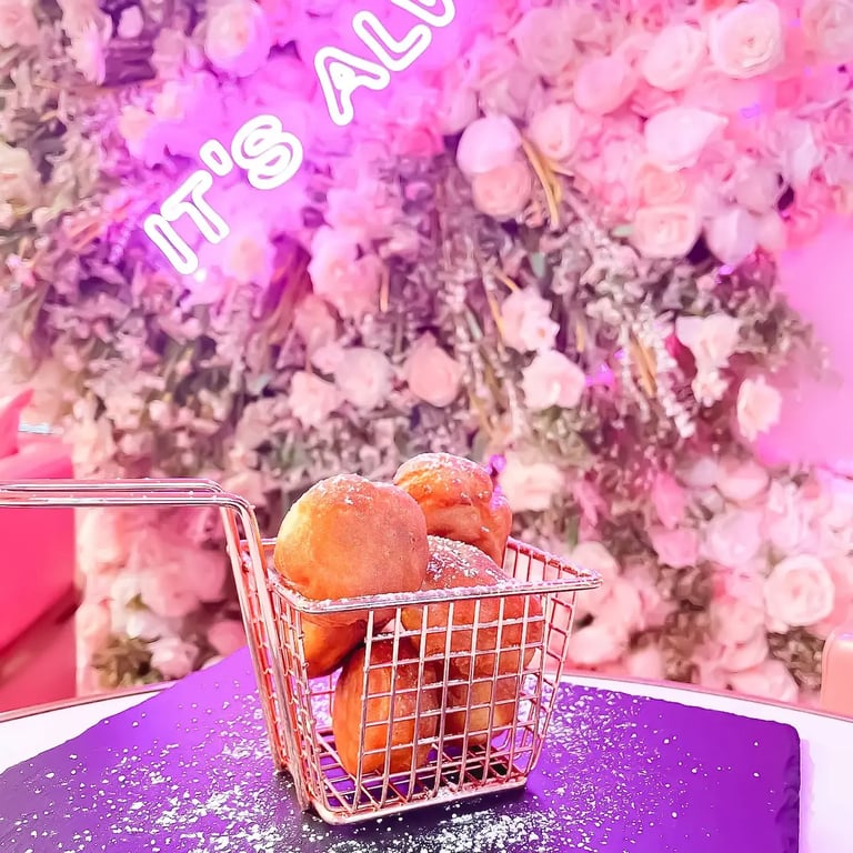 Nine powdered mini doughnut puffs from The Sweet Spot