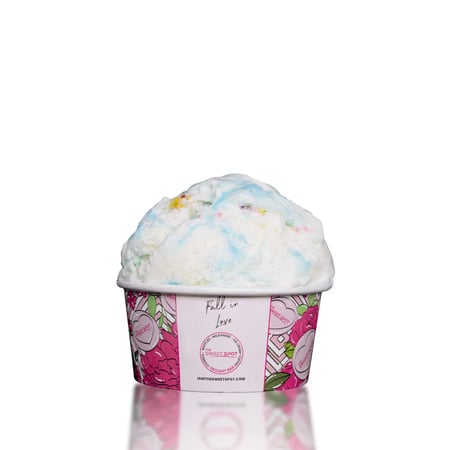 Cake batter ice cream with a frosting swirl and confetti sprinkles.