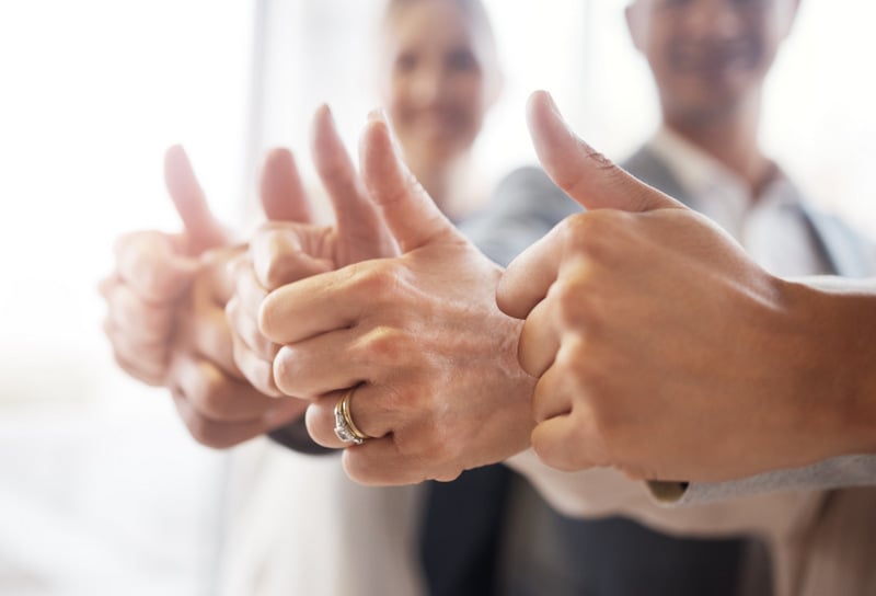 A Scrum team thumbs up celebrating the success.