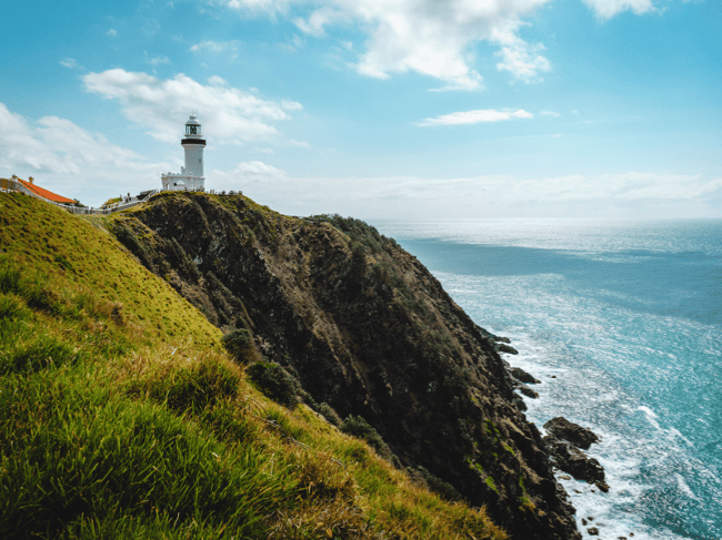 East Coast Australia itinerary featuring surfers at Byron Bay beach