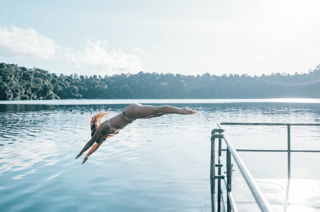 Diving of the dock at Lake Eacham on the Atherton Tablelands Cairns Adventure Package Happy Travels