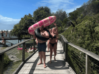 http://Friends%20carrying%20inflatable%20tubes%20on%20the%20boardwalk%20at%20Eli%20Creek%20K'gari%20Fraser%20Island