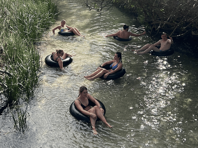 Travellers floating down Eli Creek on tubes K'gari Fraser Island