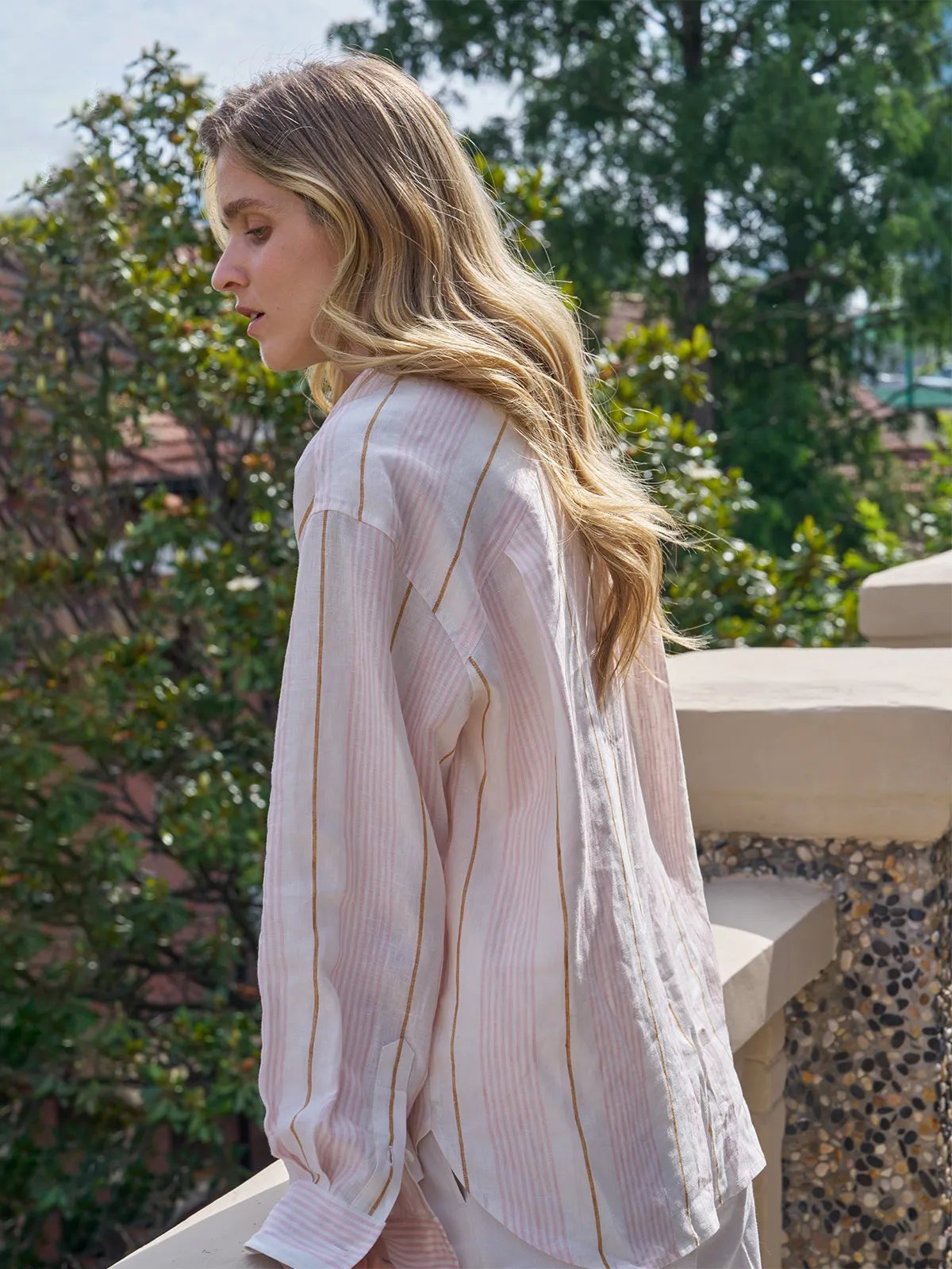 Side profile of MYRA linen shirt showing cross-back design and drape