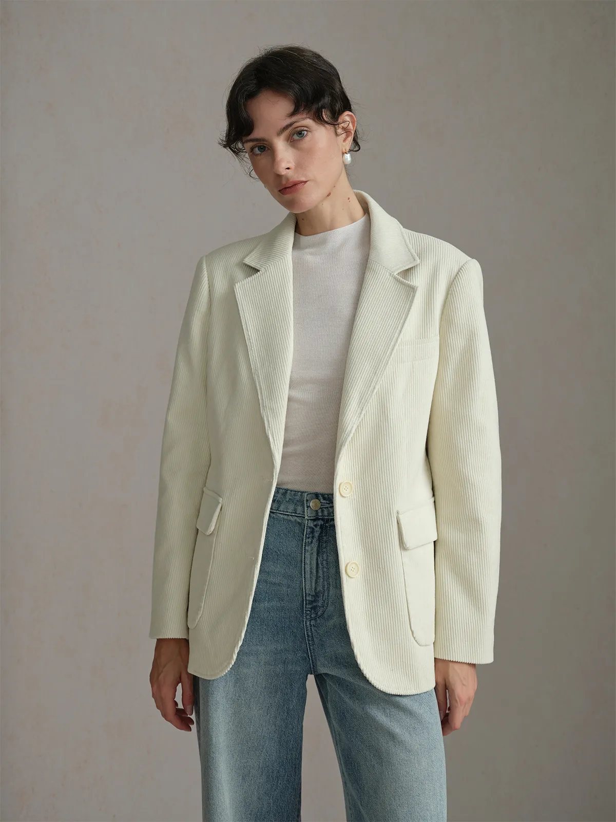Front three-quarter view of KIMBERLEY blazer with beige knit top and blue jeans