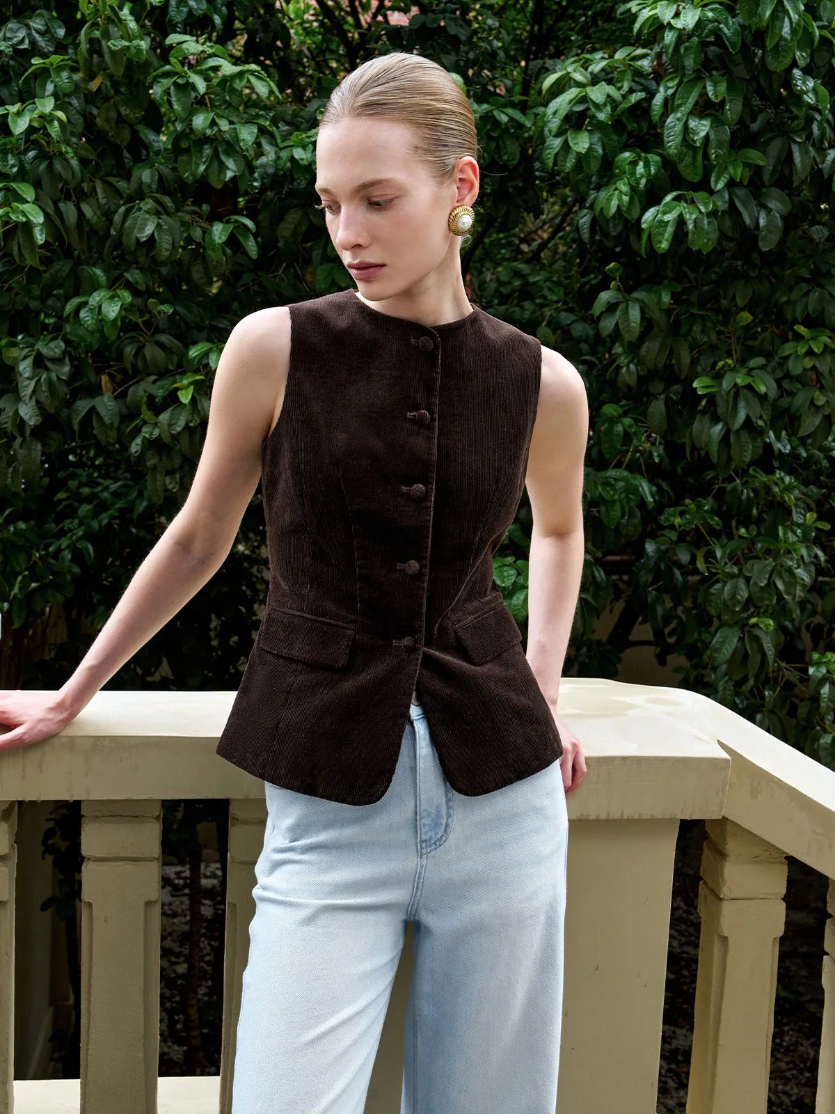 AIDAN corduroy vest paired with light wash wide-leg jeans outdoors on balcony