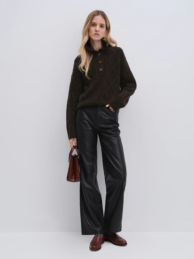 Model wearing andreatang dark brown yak and wool buttoned collar sweater with black wide-leg trousers